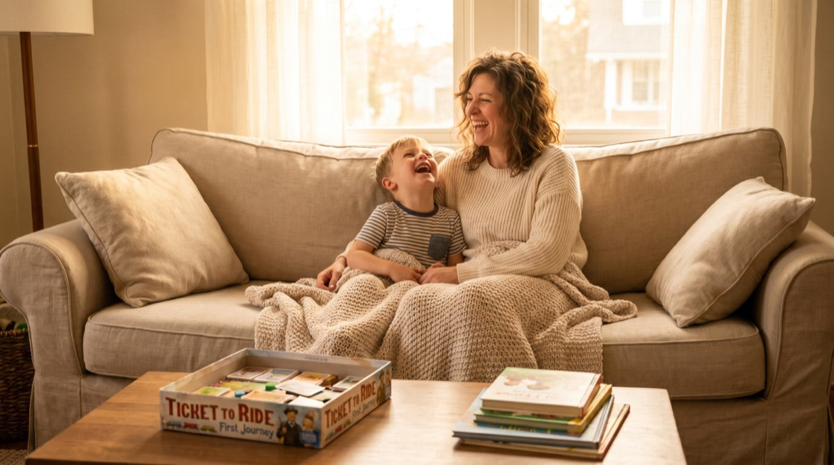 A calm evening at home — mom and son laughing on the couch